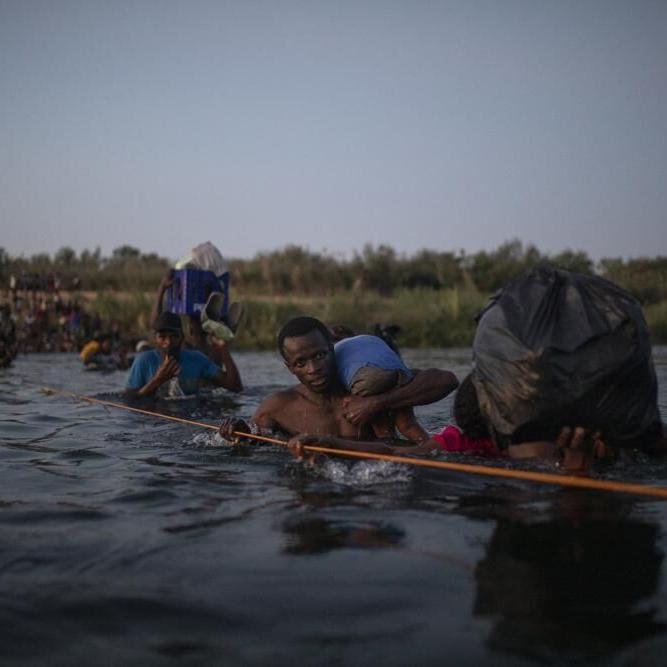 Migrants from Haiti cross Rio Grande